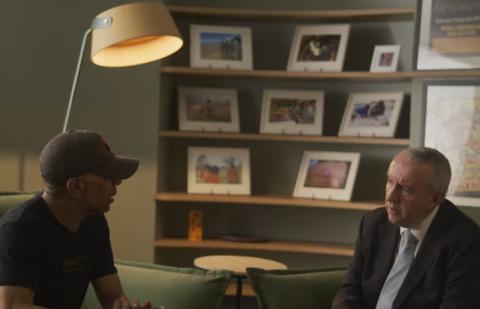 Two men sitting down having a conversation