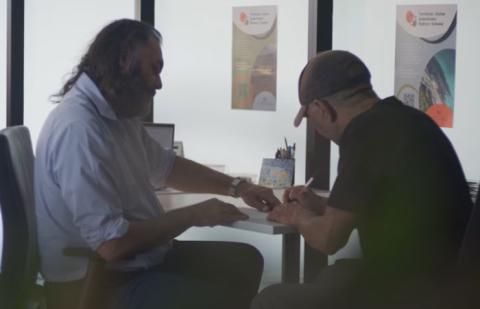 Two men at a desk going over documents
